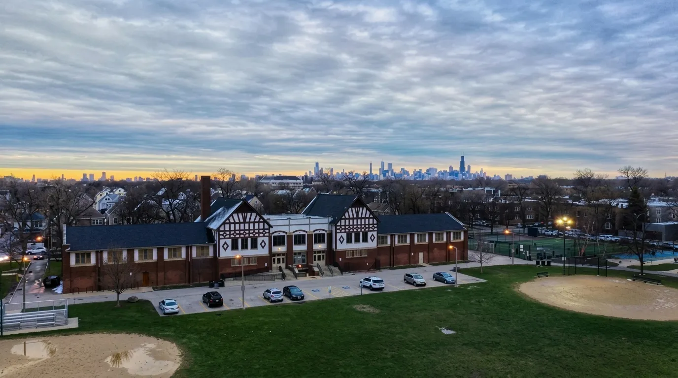 The Kosciuszko Park fieldhouse at dusk, with the Chicago skyline beyond